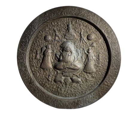A LARGE BRASS TRAY, NORTHERN INDIA, CIRCA 1900 of circular form, the repousse decoration comprising a central figure of Ganes