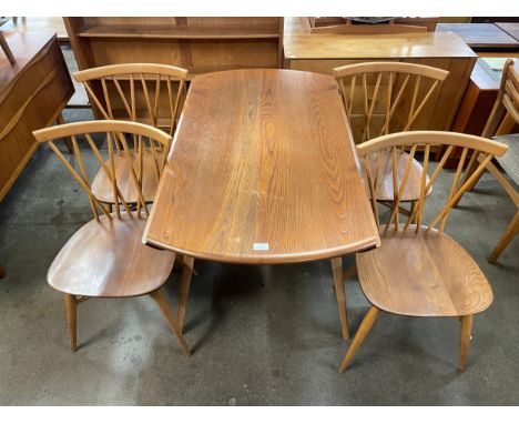 An Ercol Blonde elm and beech Windsor drop-leaf table and four candlestick back chairs 
