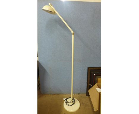 A cream metal floor standing anglepoise lamp 