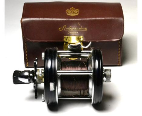 An Abu Ambassadeur 5000C Multiplying Reel, with black enamel finish, in leather case