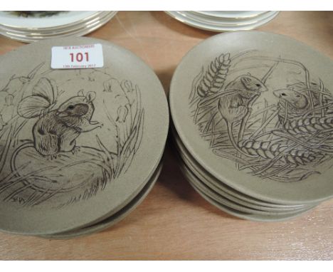 A set of twelve Poole Pottery dishes featuring wildlife relief designs