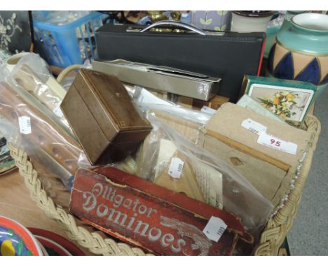 A basket containing wooden games, playing cards and vintage dominoes 