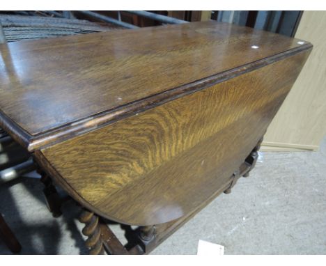 A mid 20th Century oak twist gate leg dining table