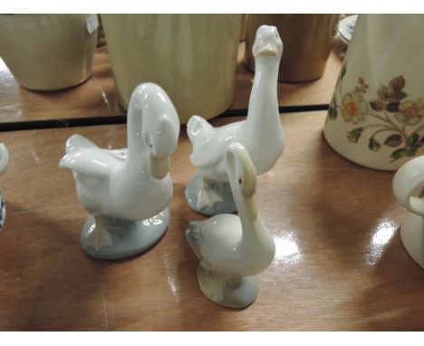 Two Nao geese figurines and another similar