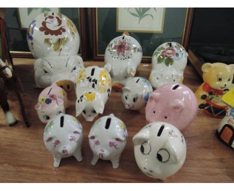 A collection of floral decorated ceramic piggy banks