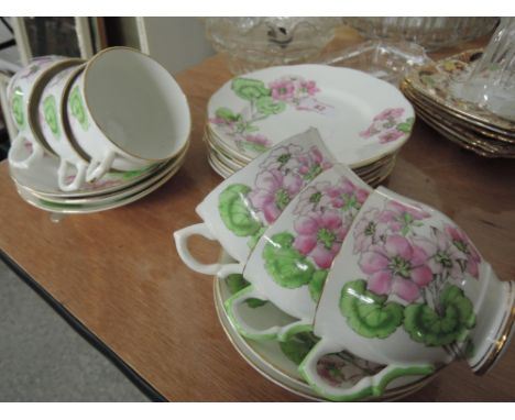 A part tea service with pink geranium decoration