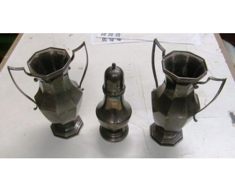 A pair of silver two handled vases and a sugar sifter