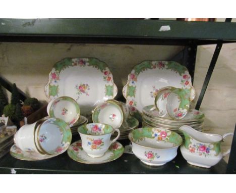 An Aynsley green and floral pattern teaset:- twelve cups and saucers, eleven tea plates, two serving plates, sucrier and jug