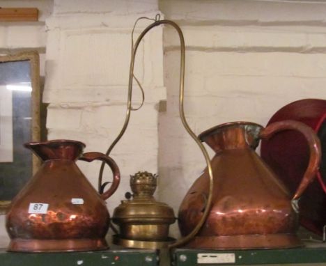 Two copper harvester jugs and a brass lantern