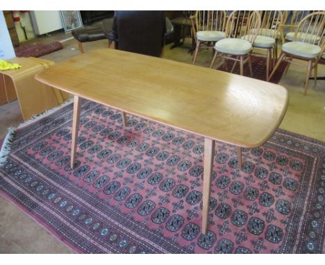 A light Ercol table and six chairs, chairsslightly faded if anything