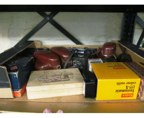 A box of cased and other vintage cameras