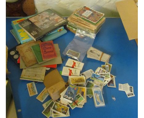 An Austin A40 service manual, other car manuals, cigarette cards, Scout books and an 1816 family bible