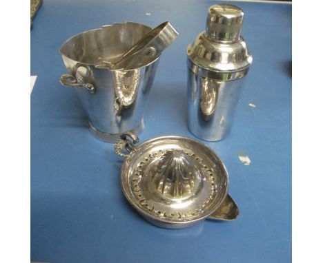 A silver-plated cocktail shaker, ice bucket, tongs and lemon squeezer