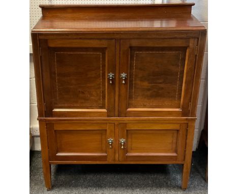 An Edwardian mahogany two tier cabinet / cupboard, quarter galleried top, large pair cupboard doors, over smaller pair, taper