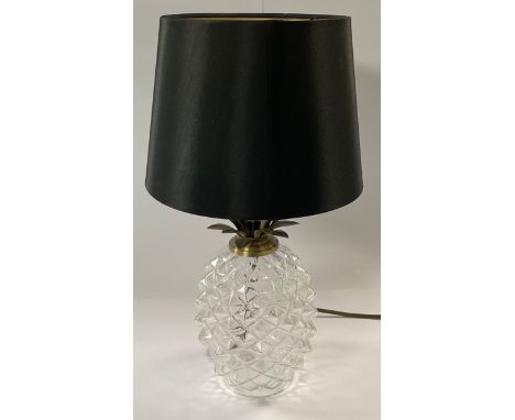 A novelty clear glass table lamp in the form of a pineapple, black shade, 46cm high overall 