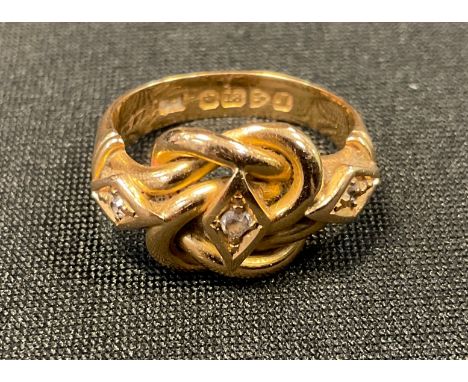 A diamond ring, rope knot crest set with three old brilliant cut diamond accents,  18ct gold shank, Chester 1912,  size K, 5.