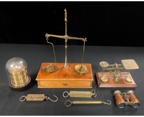 A set of early 20th century brass apothecary balance scales and weight, mounted on mahogany base with single drawer, 38cm hig