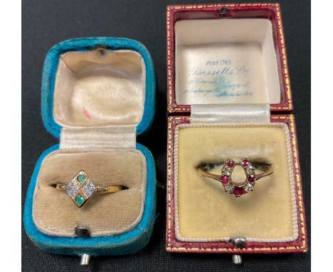 A diamond and ruby horseshoe ring, unmarked gold coloured metal shank, size P, 2g gross;  diamond and emerald lozenge cluster