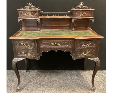 An early 20th century reproduction Louis XIV / Rococo style mahogany writing desk, carved cresting, quarter galleried back wi