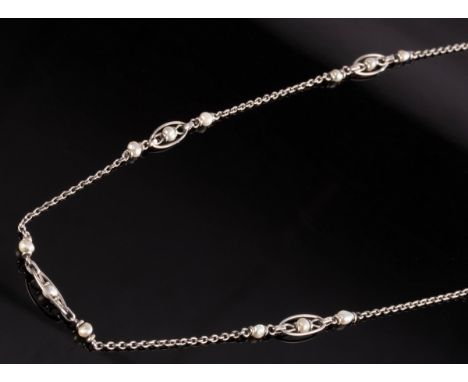 A fine link pearl set necklace, the long white precious metal chain interspersed by pearls and caged pearls, unmarked, 45cm l