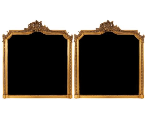 A pair of gilt framed overmantel mirrors, the crests with shell and scroll decoration, the mirror plates with arched top, tot