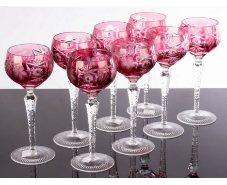 A set of eight wine glasses, the ruby coloured bowls with cut decoration, 21cm high CONDITION REPORT: Condition information i