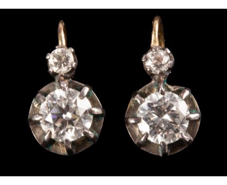 A pair of diamond earrings, each set with two stones, the larger approximately 0.4ct, French marks to the setting, approximat