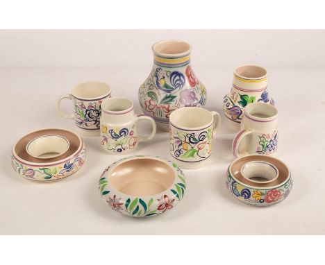 Poole Pottery, four floral mugs, two floral vases, the tallest 17.5cm high, two floral posy rings, the largest 14cm diameter 