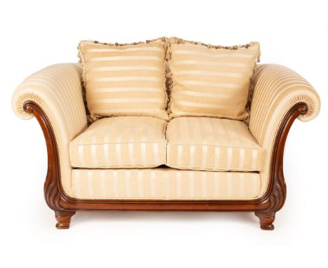 A Victoria furniture two-seat sofa, with carved scroll ends on turned feet, 163cm wide/see illustration/Provenance: Purchased