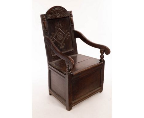 A 17th Century oak wainscot chair with arch-top panelled back, scroll arms and box seat CONDITION REPORT: Condition informati