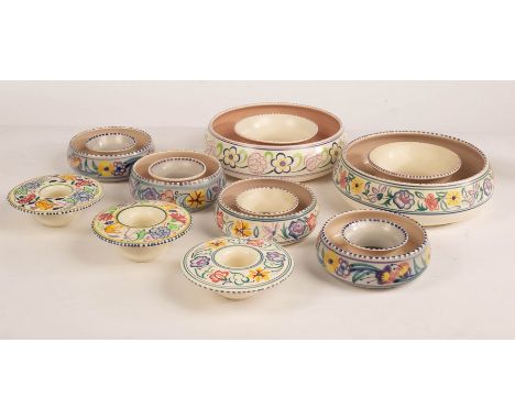 Poole Pottery, two large floral posy rings, one with incised pottery mark, 22cm diameter, four smaller posy rings, 14cm diame