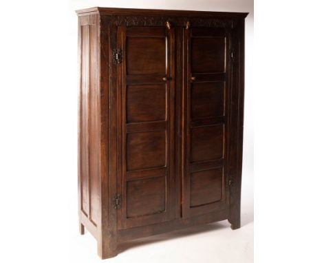 An oak two-door Jacobean style wardrobe with carved frieze, 127cm wide CONDITION REPORT: Split to left hand pillar. Rocks sli