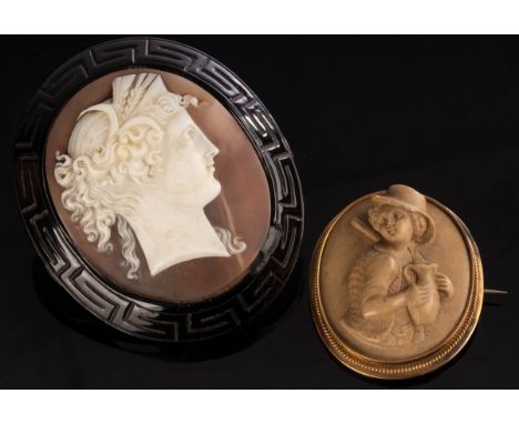 A large oval shell cameo brooch depicting a Classical lady in profile, within an outer black border of Greek key design, 6.5c