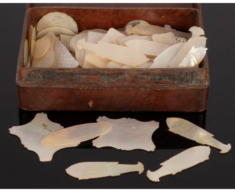 A quantity of mother-of-pearl gaming counters, approximately one hundred and fifteen rectangular-shaped and twenty-one fish-s