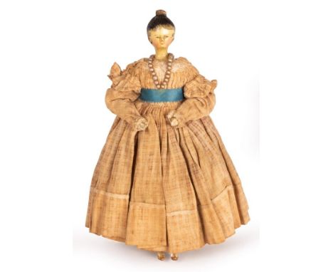 A Grodnertal 18th Century painted wooden doll with moulded hair piece, wooden arms and legs, in original dress, 21cm high/see