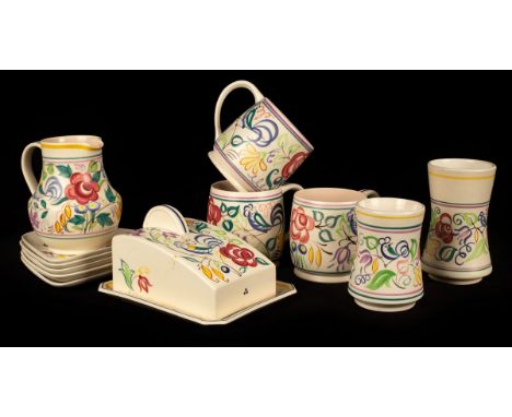 Poole Pottery, a floral cheese dish and cover, 19cm long, three floral tankards, 11cm high, a floral jug, 14cm high and two f