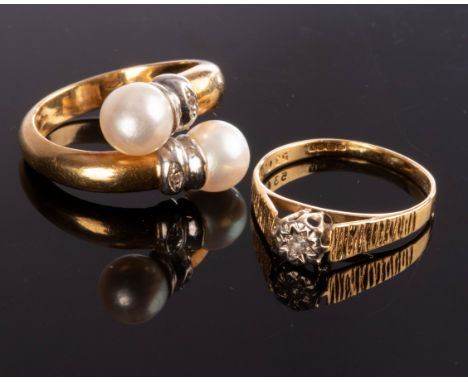 A diamond ring set in 18ct yellow gold, Birmingham 1973, with textured shoulders approximately 2gm, size M, and a pearl cross