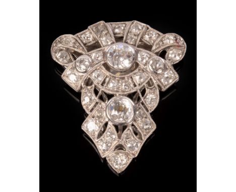A diamond clip brooch of openwork form, set in white precious metal, the two principal stones of approximately 0.4ct and 0.3c