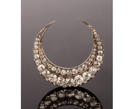 A Victorian diamond crescent brooch, set with two rows of graduated cushion-shaped stones, the silver fronted gold setting wi