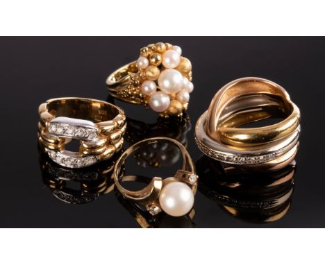 A bi-colour gold dress ring set with a line of small diamonds, a 14k gold ring of buckle form and two pearl dress rings set i