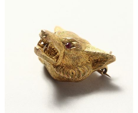 A 9CT GOLD FOX HEAD BROOCH with ruby eyes. 10.8cts.