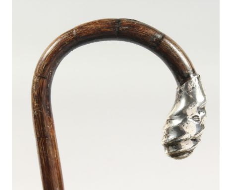 A WALKING STICK with silver handle. 3ft long.