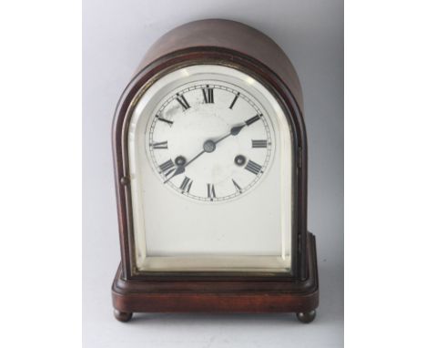 A 1930'S-1940'S MAHOGANY MANTLE CLOCK, with silvered dial on four bun feet. 11ins high.