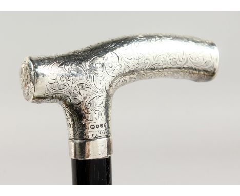 A VICTORIAN ENGRAVED SILVER HANDLED WALKING STICK. London 1889.  Maker: C. W.  3ft long.