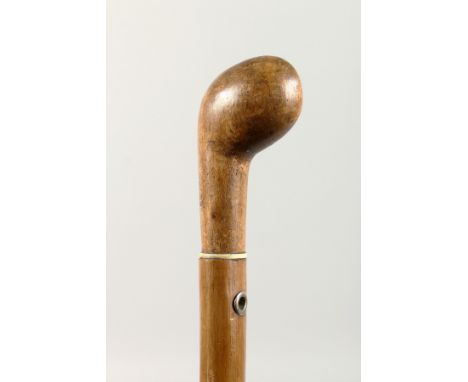 A WOODEN WALKING STICK. 2ft 10ins long.