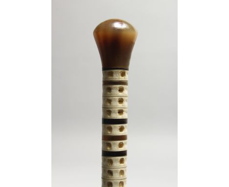 A WHALEBONE VERTEBRAE WALKING STICK with bone handle. 2ft 9ins long.