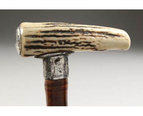 A VICTORIAN WALKING STICK with antler handle and silver collar. 2ft 10ins long.