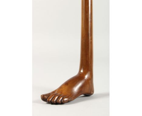 A VERY UNUSUAL CARVED WOOD ONE-PIECE WALKING STICK, the handle as a foot. 2ft 11ins long.