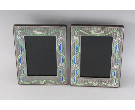 A PAIR OF NOUVEAU SILVER AND ENAMEL PHOTOGRAPH FRAMES. 7.5ins x 6ins.