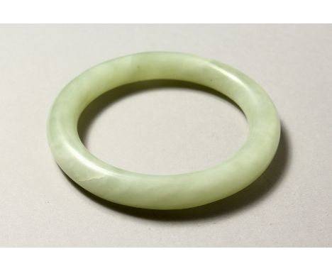 A JADE BANGLE. 8cm diameter. 58mm internal diameter.